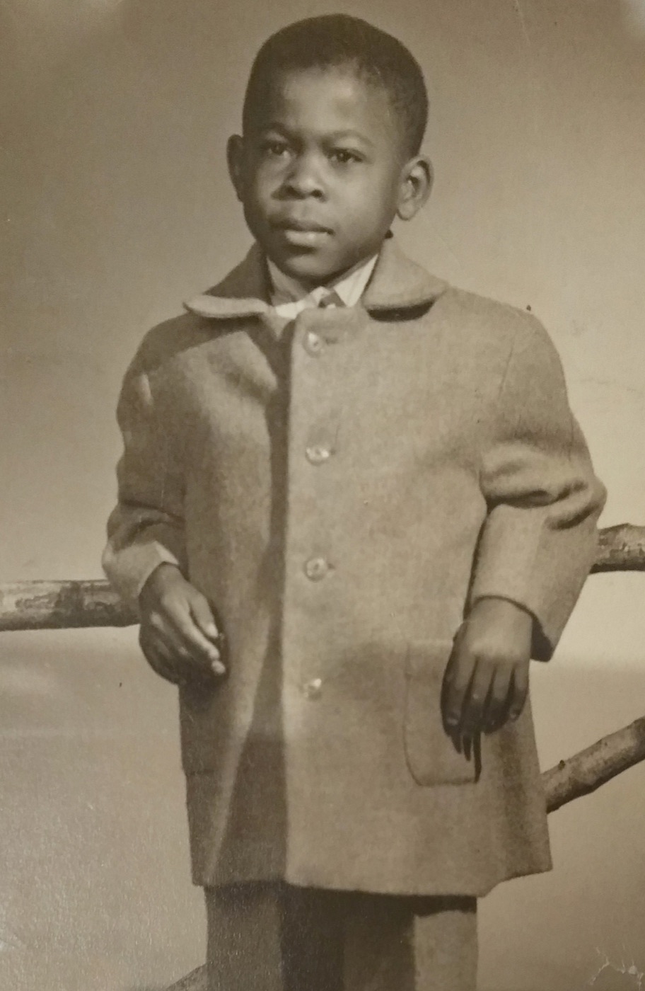 James E. Lyons Sr. as a young boy, in a coat and tie